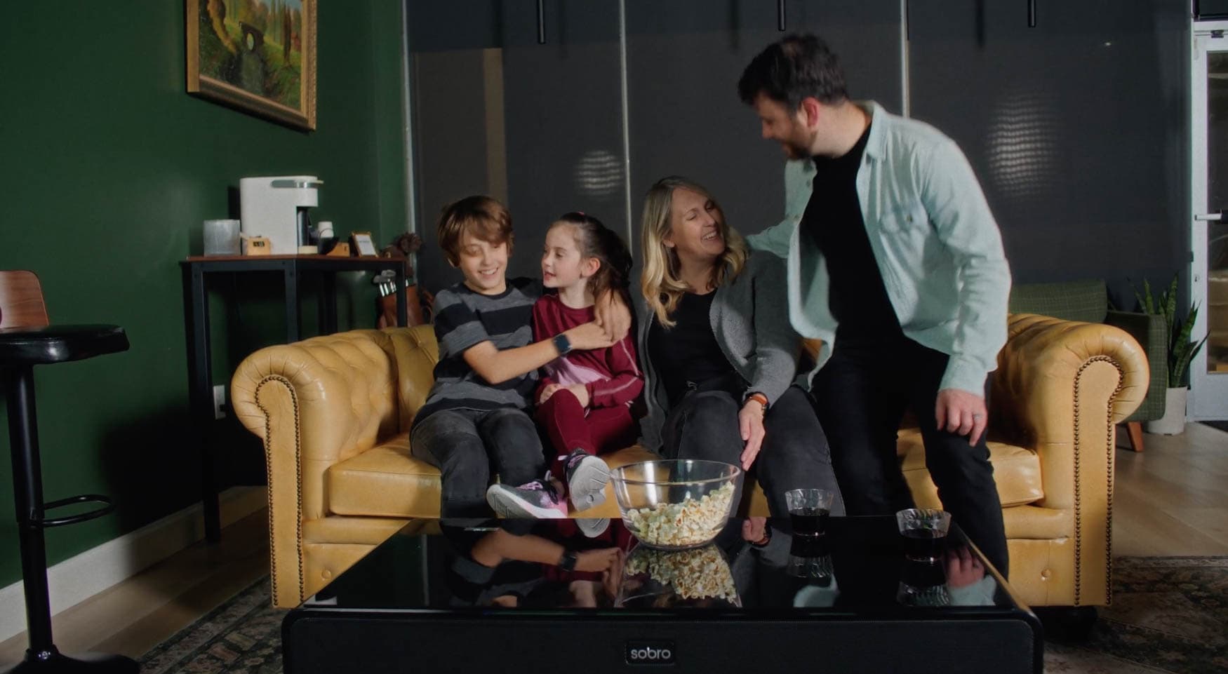 family relaxing on the chesterfield sofa